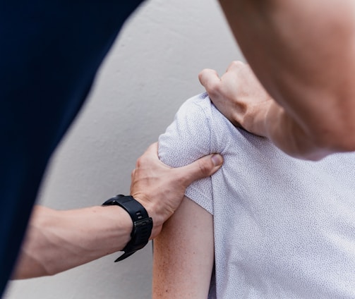 a woman holding onto a man's arm