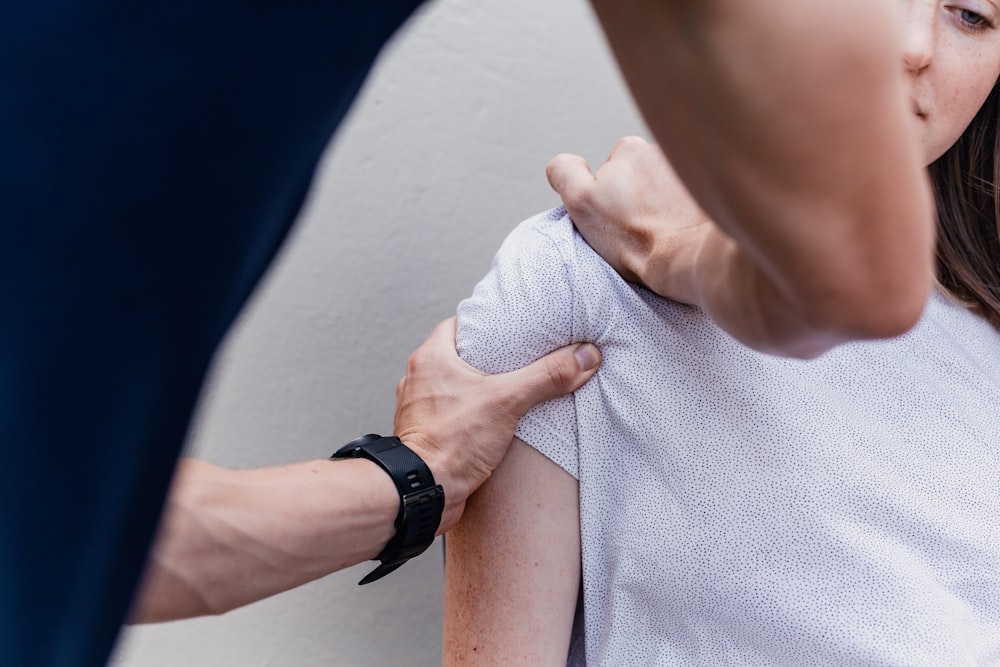 a woman holding onto a man's arm