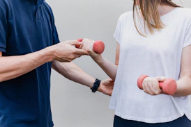 a man and a woman holding dumbs in their hands