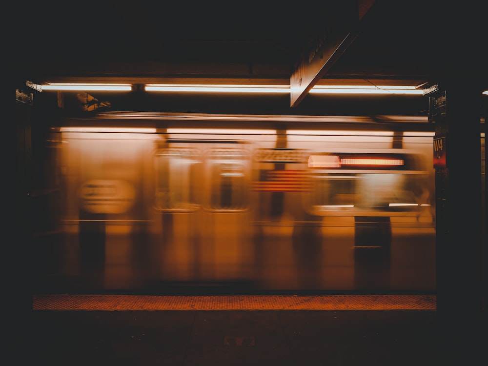 a blurry photo of a subway train at night