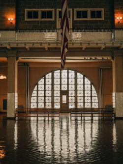 a large room with a flag hanging from the ceiling
