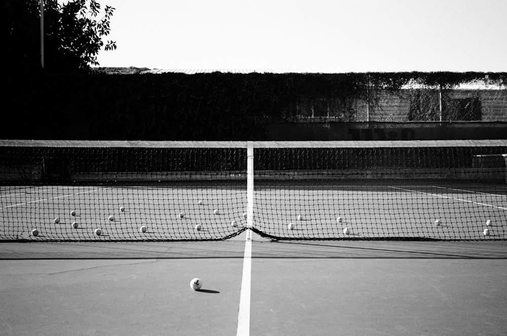 a black and white photo of a tennis court