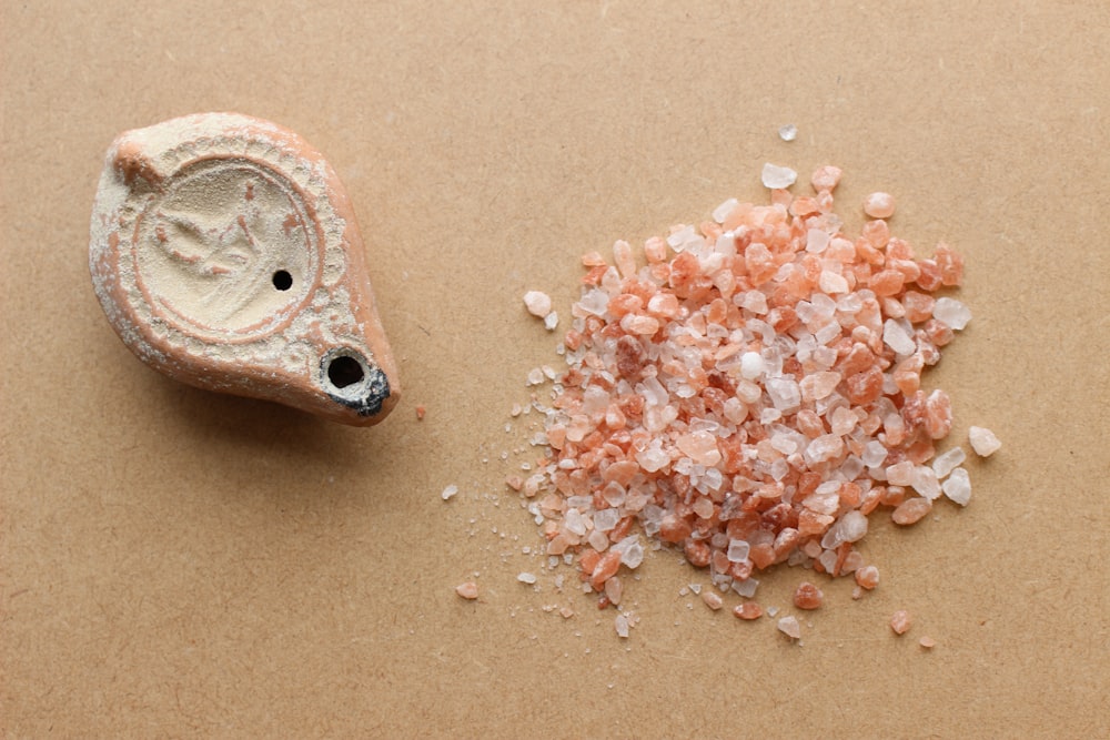 a pile of sea salt next to a small piece of stone