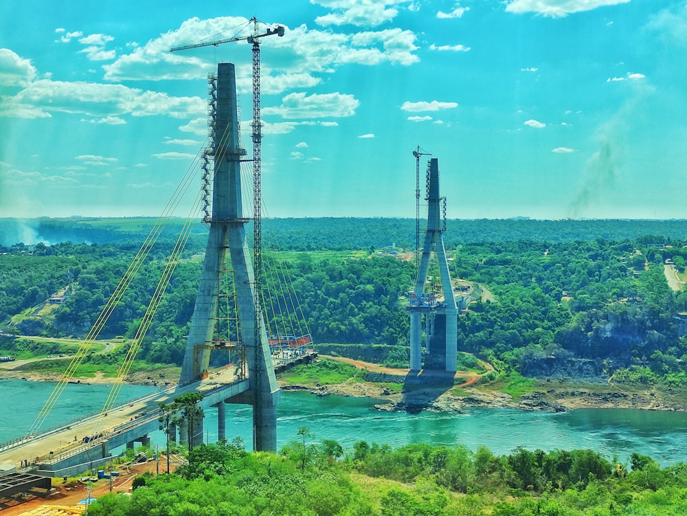 a large bridge over a river surrounded by trees