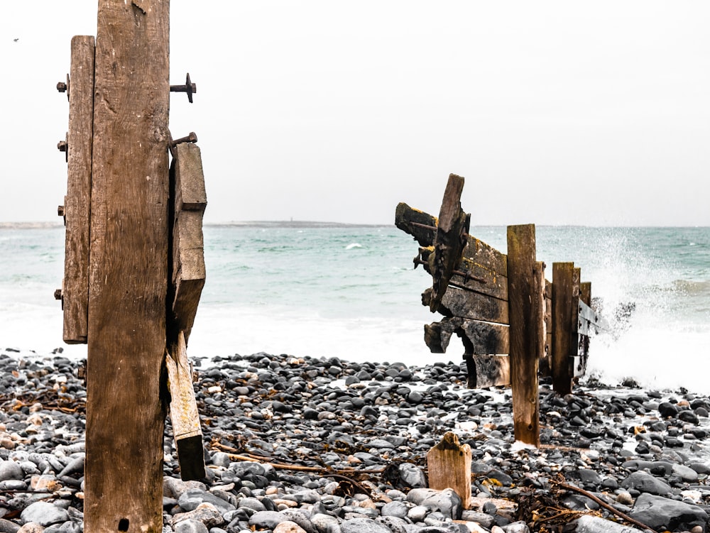 a wooden structure sitting on top of a rocky beach