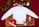 A white sweatshirt is laid out on a furry brown mat, surrounded by Christmas-themed decorations. These include a Santa hat, a pair of red novelty glasses with reindeer antlers, colorful ornaments, a 'Merry Christmas' sign, a small gift box, a green sock with Santa's face, a plush reindeer, and a wreath with a green bow. The background is a rich red fabric, adding to the festive atmosphere.