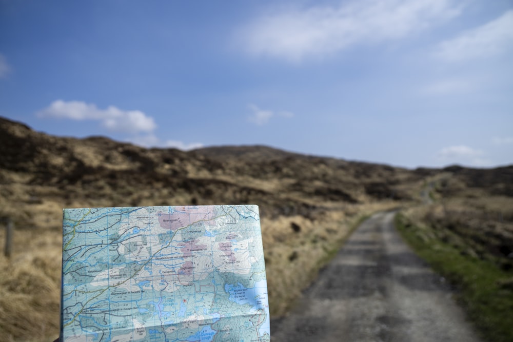 a map sitting on the side of a road