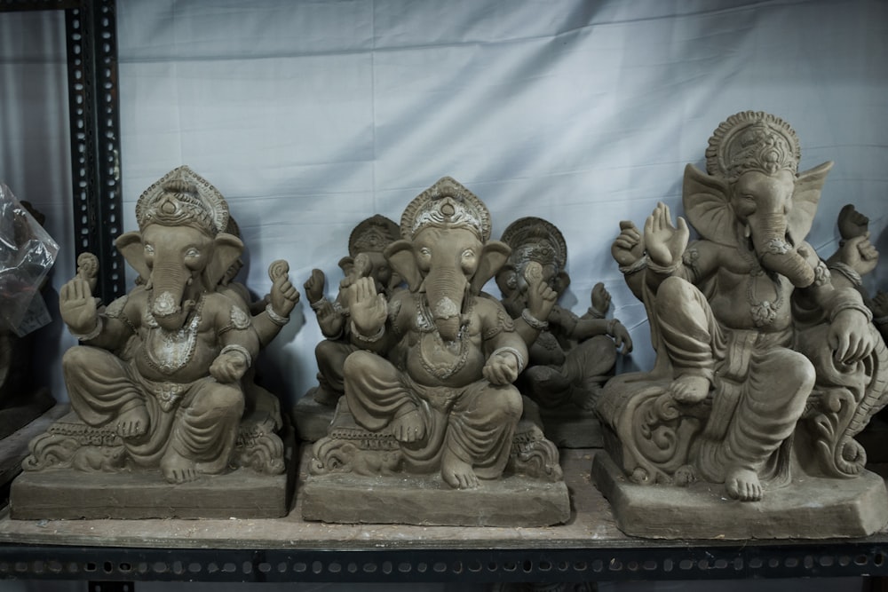 a group of statues of elephants sitting next to each other