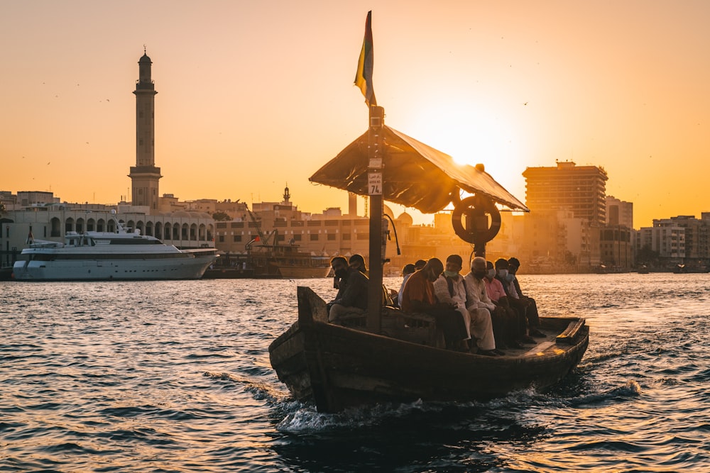 a group of people riding on the back of a boat