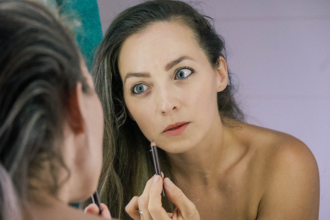 a woman is looking at her reflection in the mirror, Morning routine