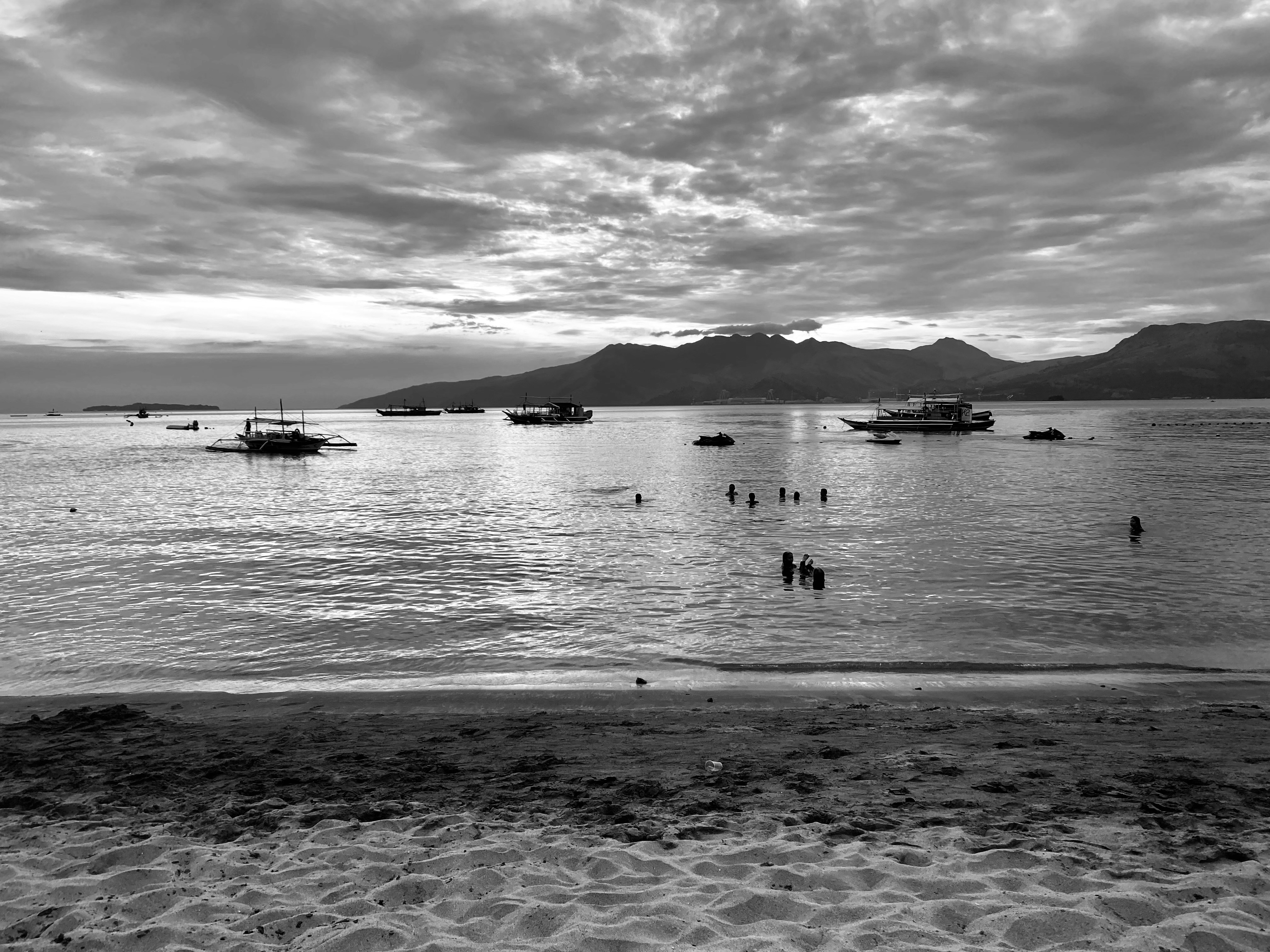 a group of boats floating on top of a body of water