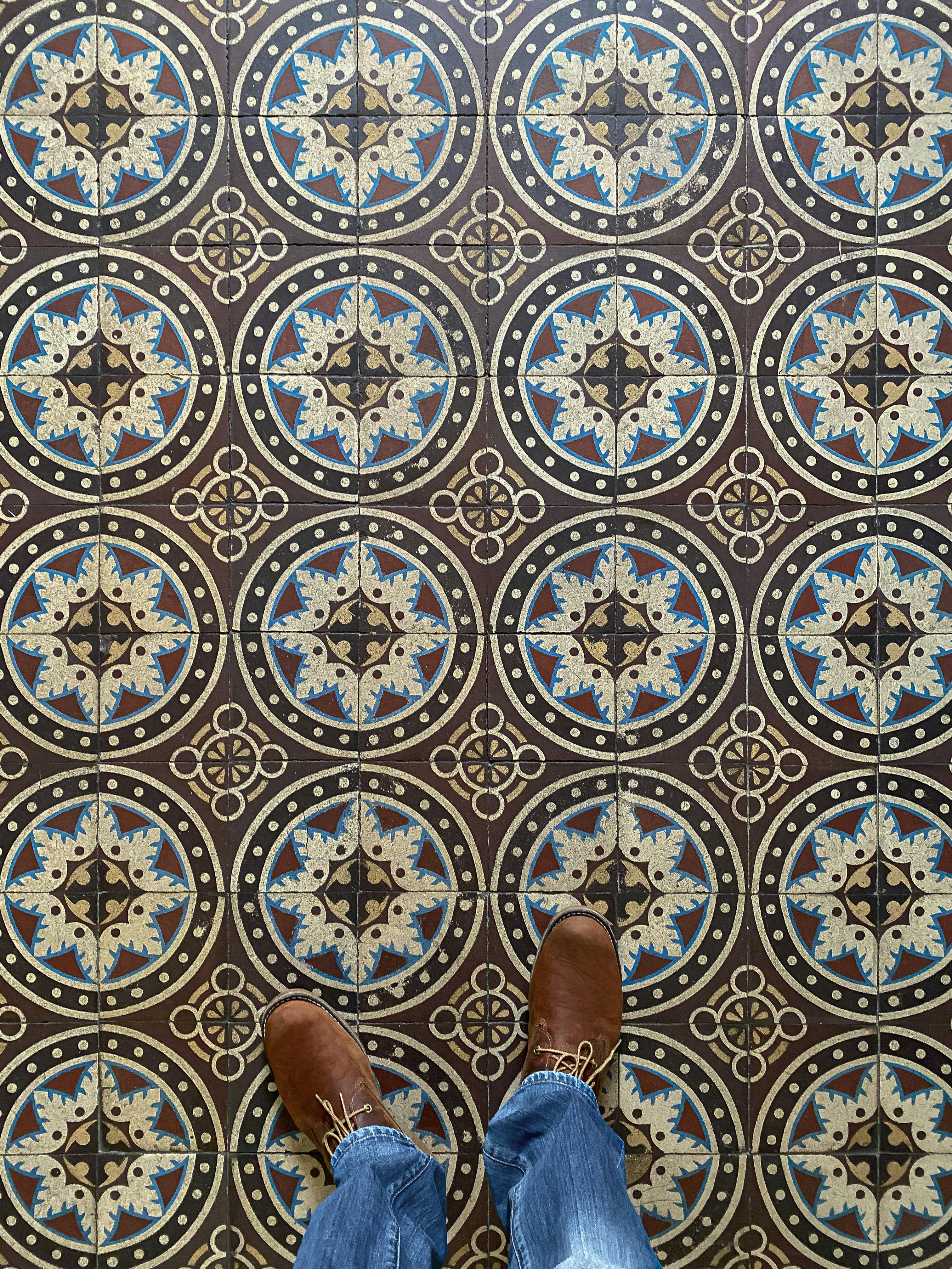 A person standing in front of a patterned floor photo – Free Pattern ...