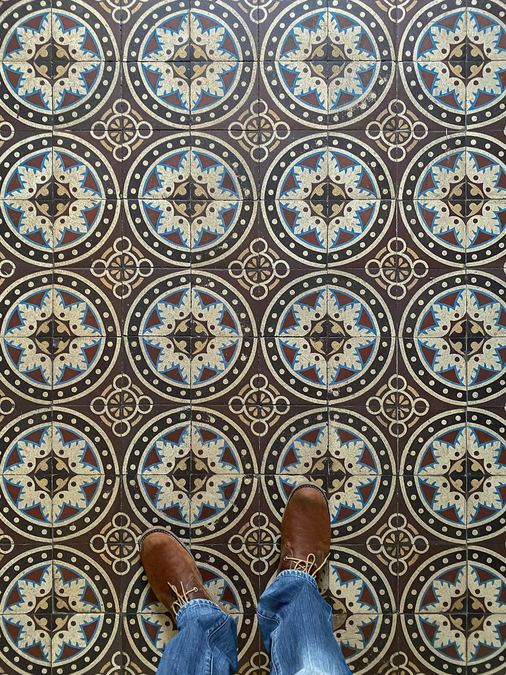 a person standing in front of a patterned floor