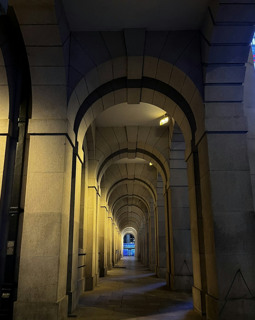a long tunnel with a clock on the side of it