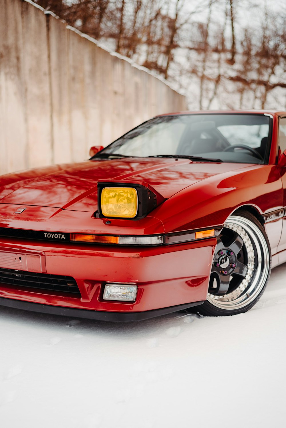 a red sports car parked in the snow