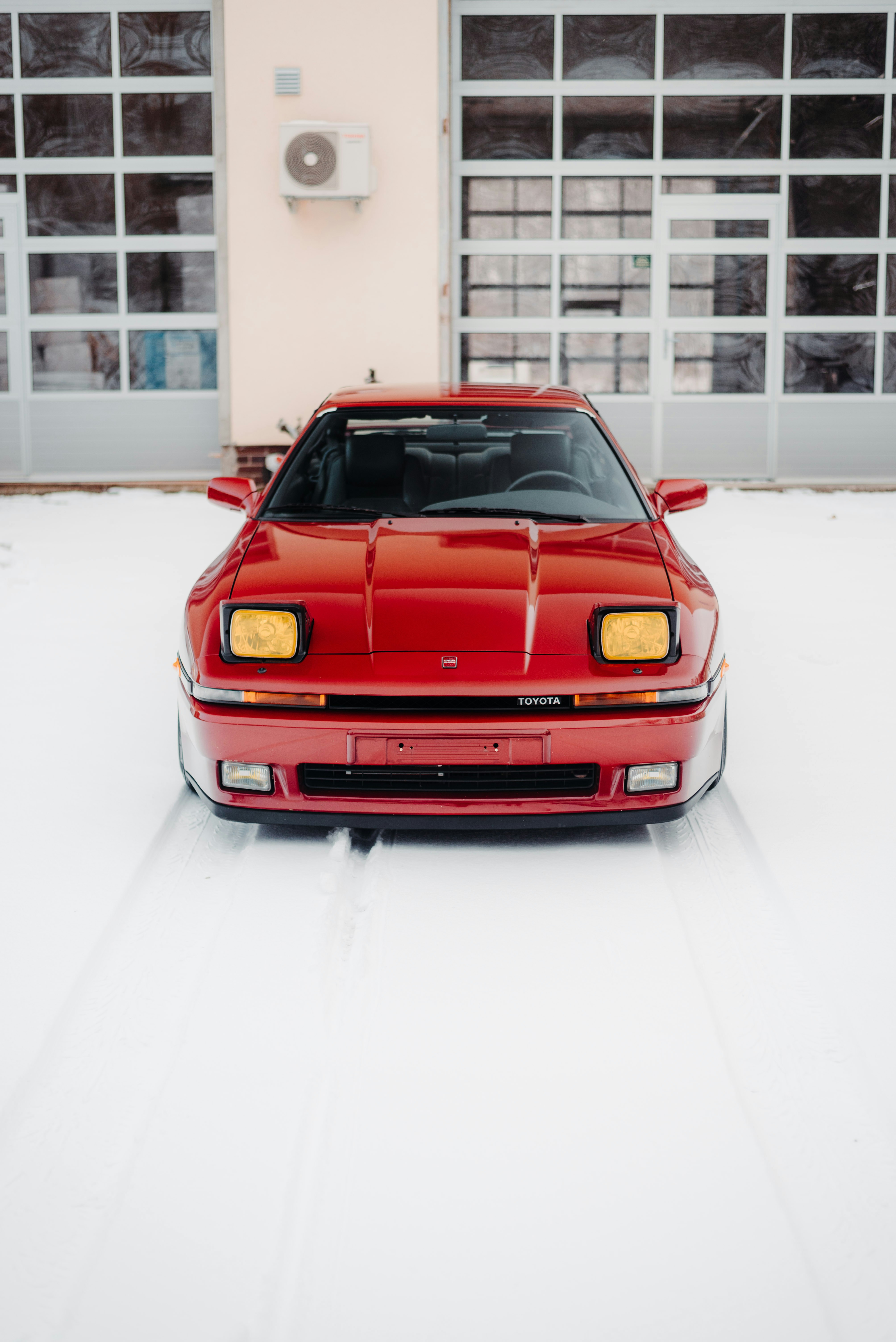 a red sports car parked in front of a building