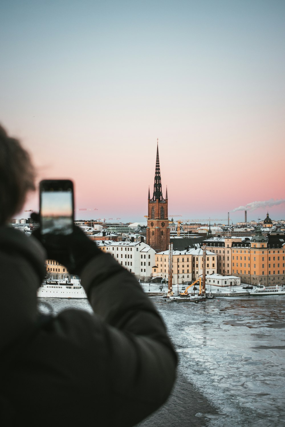 Eine Person, die ein Foto von einer Stadt mit einem Handy macht