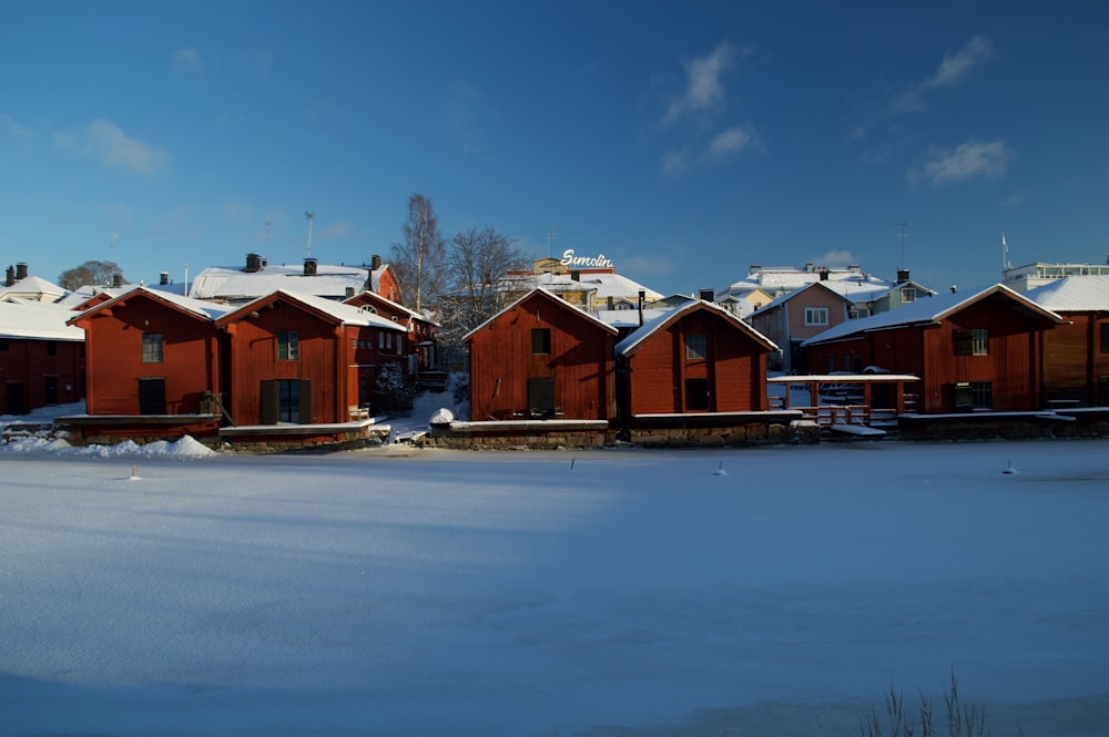 a row of red houses covered in snow