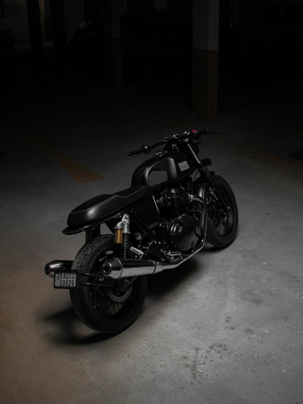 a black motorcycle parked in a parking lot