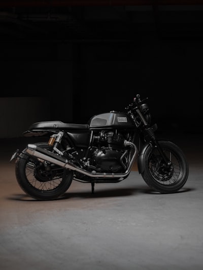 a black motorcycle parked in a dark room