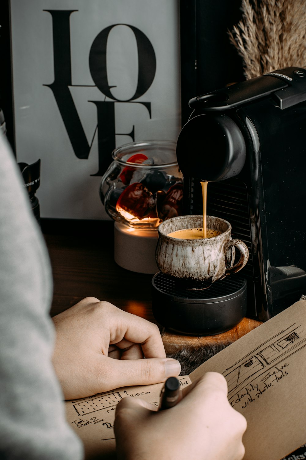 a person is pouring coffee into a cup