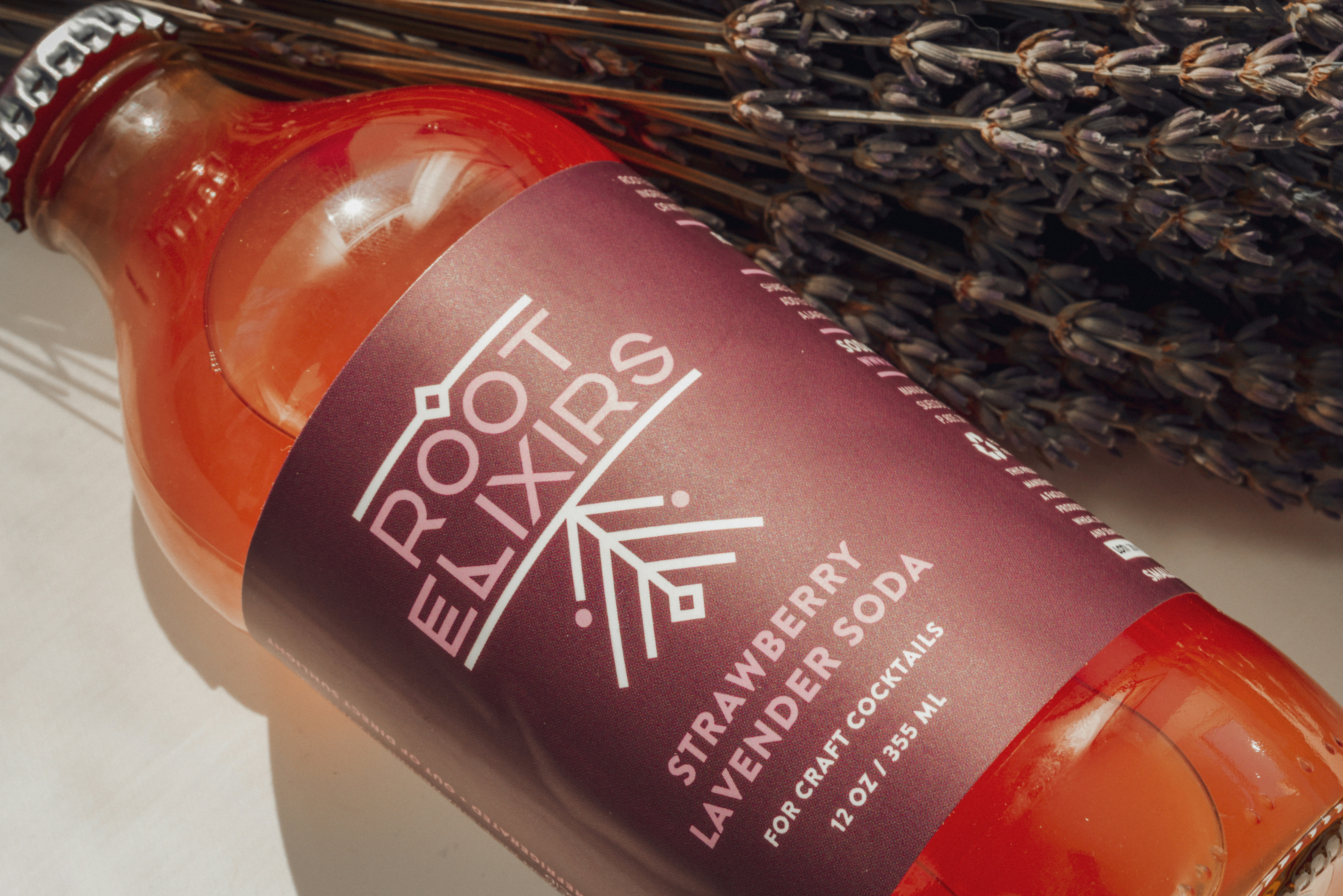 Elegant lavender spritz cocktail with dried lavender garnish and purple hue in a champagne flute at Blush Bar Atlanta