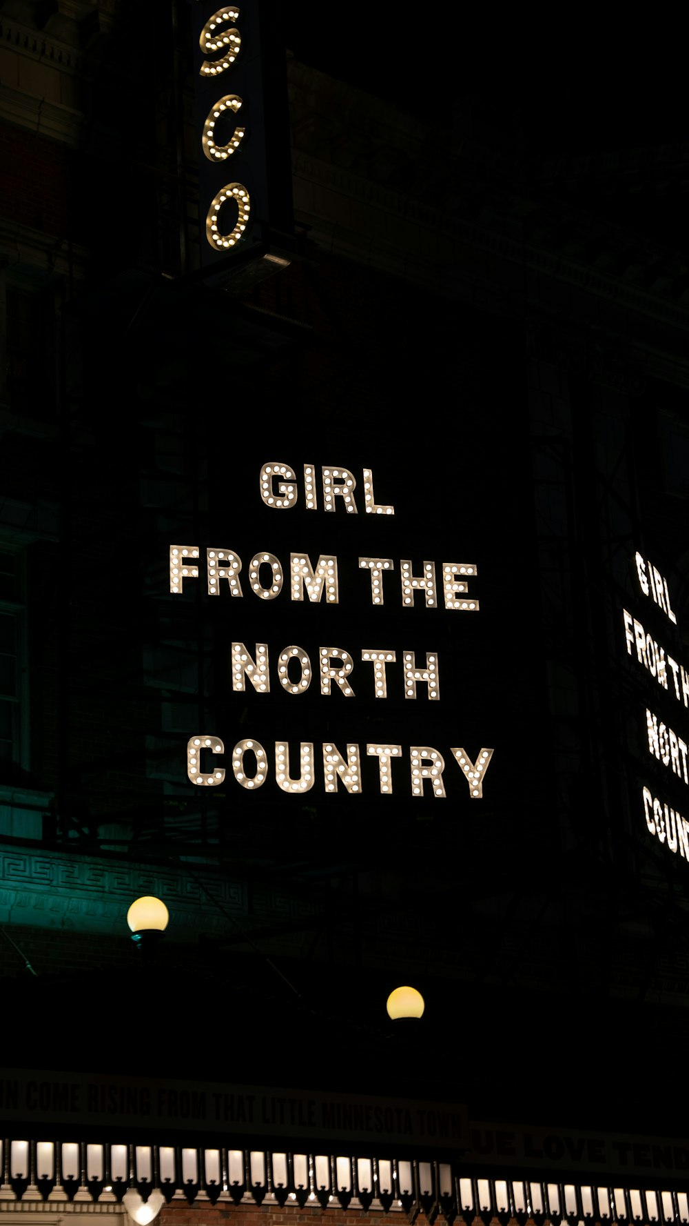 a neon sign that reads girl from the north country