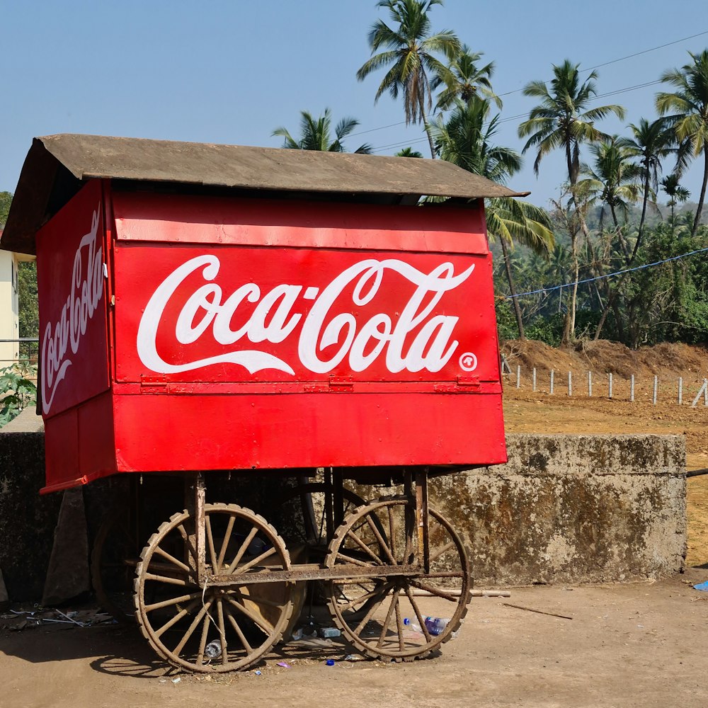 a coca - cola wagon sitting on the side of a road