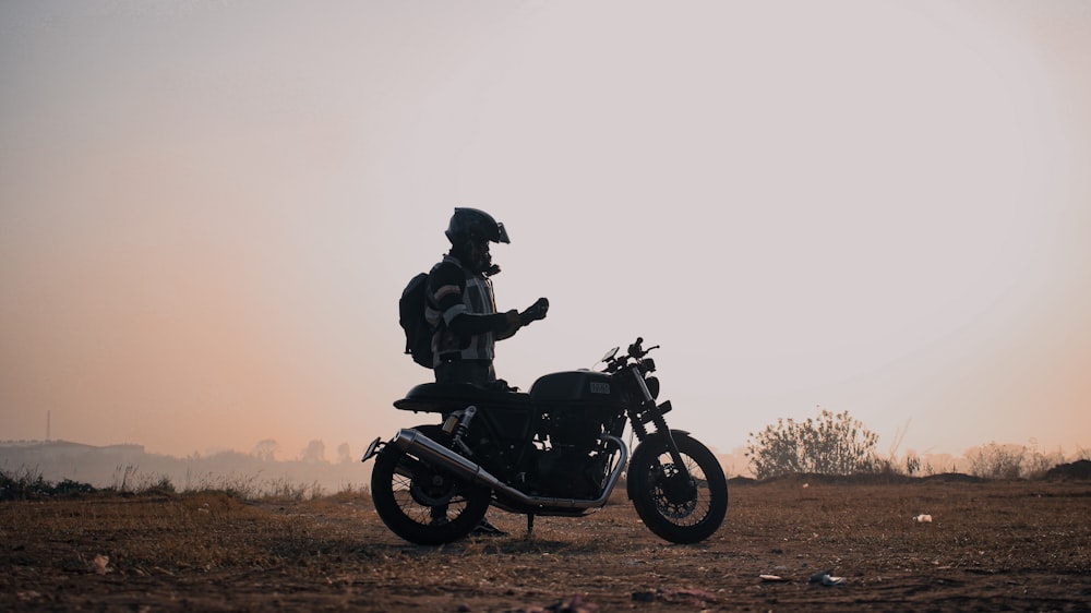 a person on a motorcycle in the middle of a field