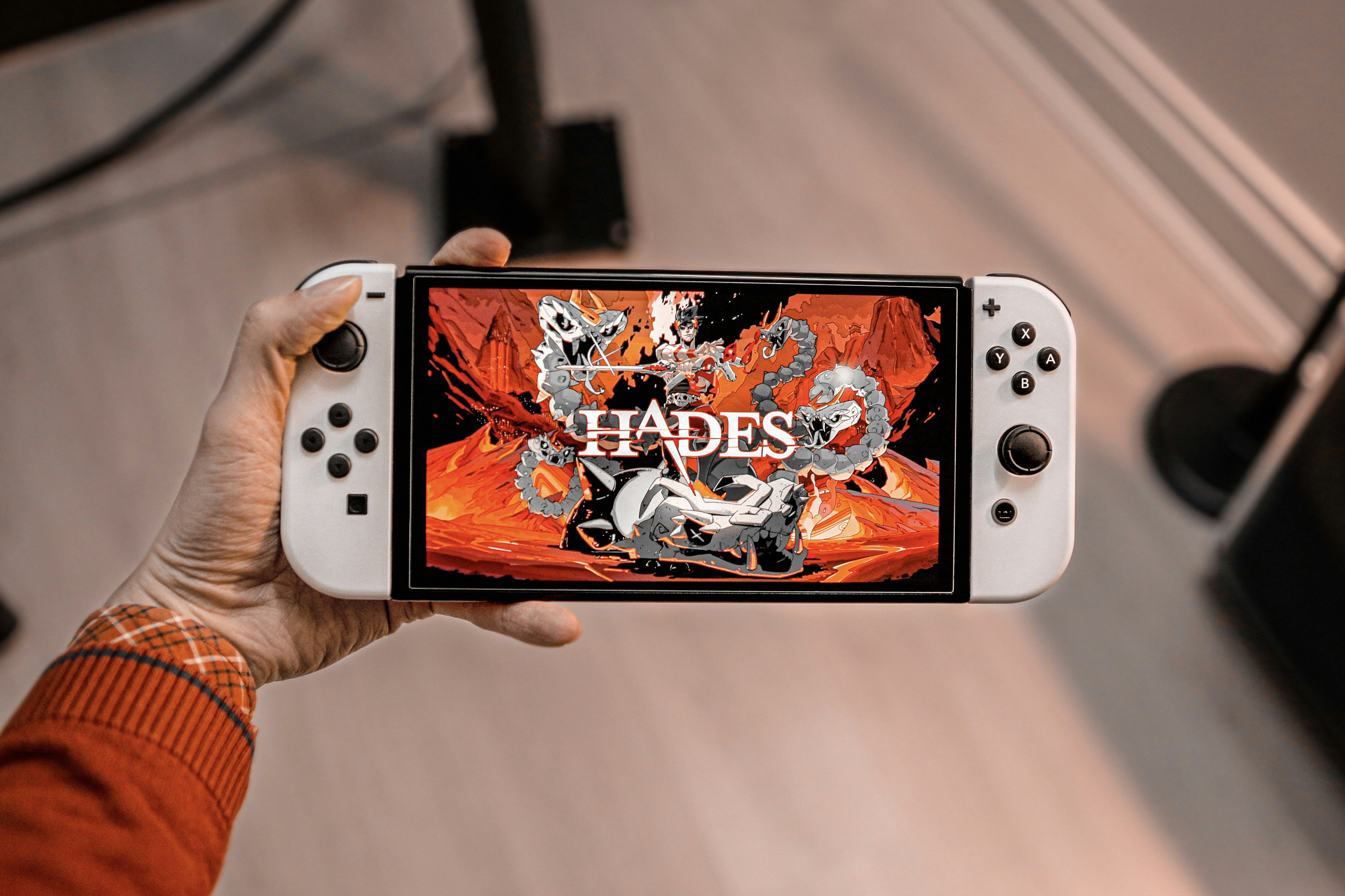 a person holding a nintendo wii game controller