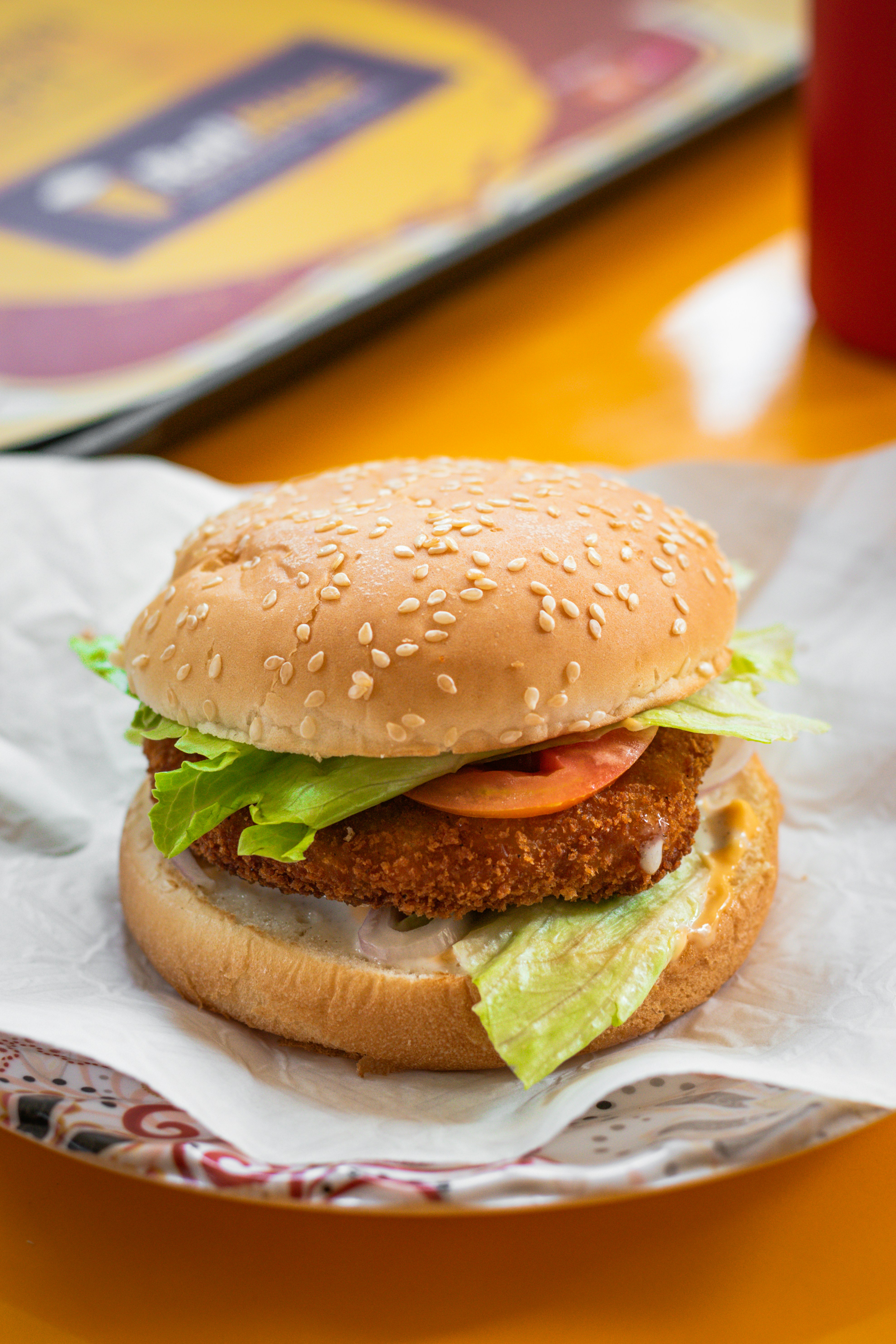 a chicken sandwich with lettuce and tomato on a bun