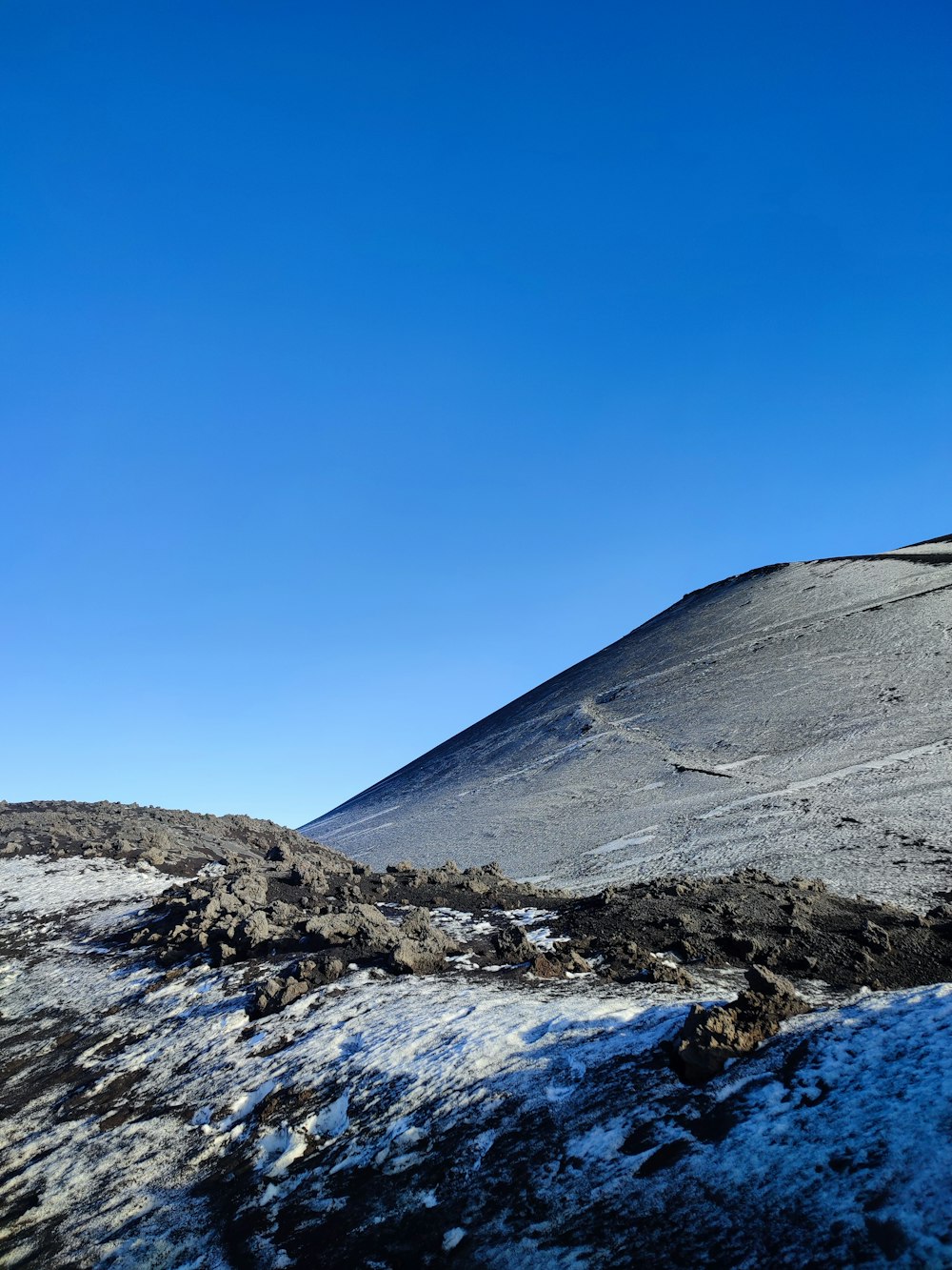 a person on a snowboard going down a hill