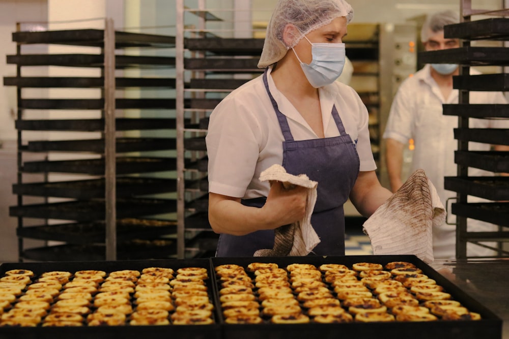 a woman wearing a face mask in a bakery