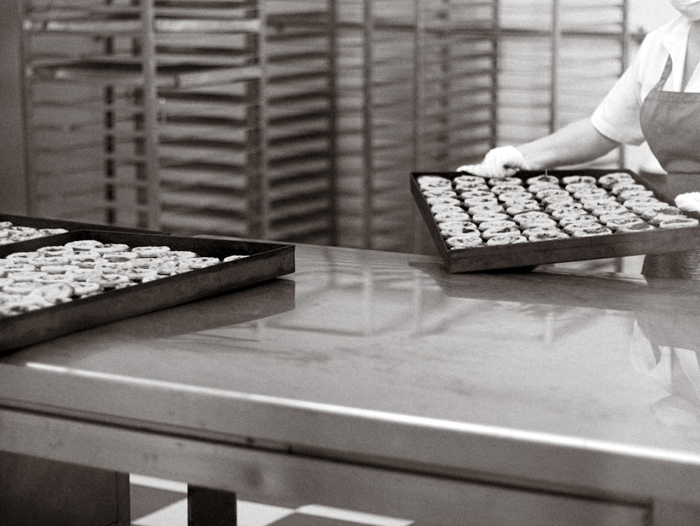 a woman in a kitchen with a tray of cookies