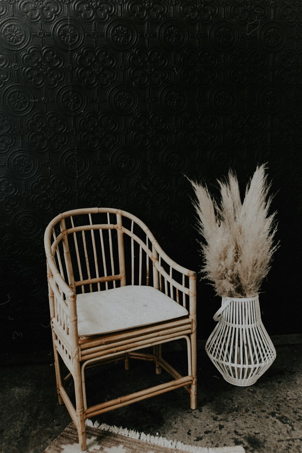 a white chair and a white vase on a rug