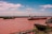 Two large cargo ships navigate a wide river under a clear, lightly clouded sky. The riverbank features some greenery and a rusted metal railing in the foreground. The larger ship, labeled 'CAMPBELL,' is moving along with the other vessel alongside.