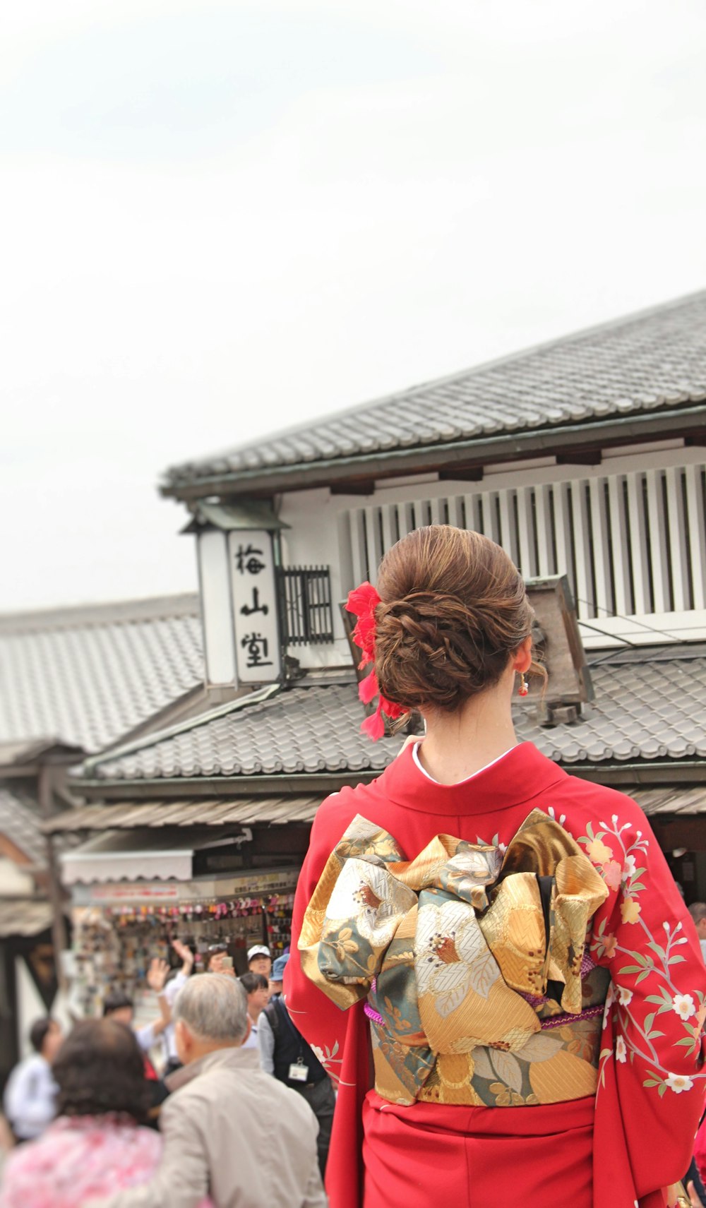 a woman in a red and gold kimono
