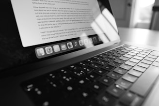 a laptop computer sitting on top of a wooden table