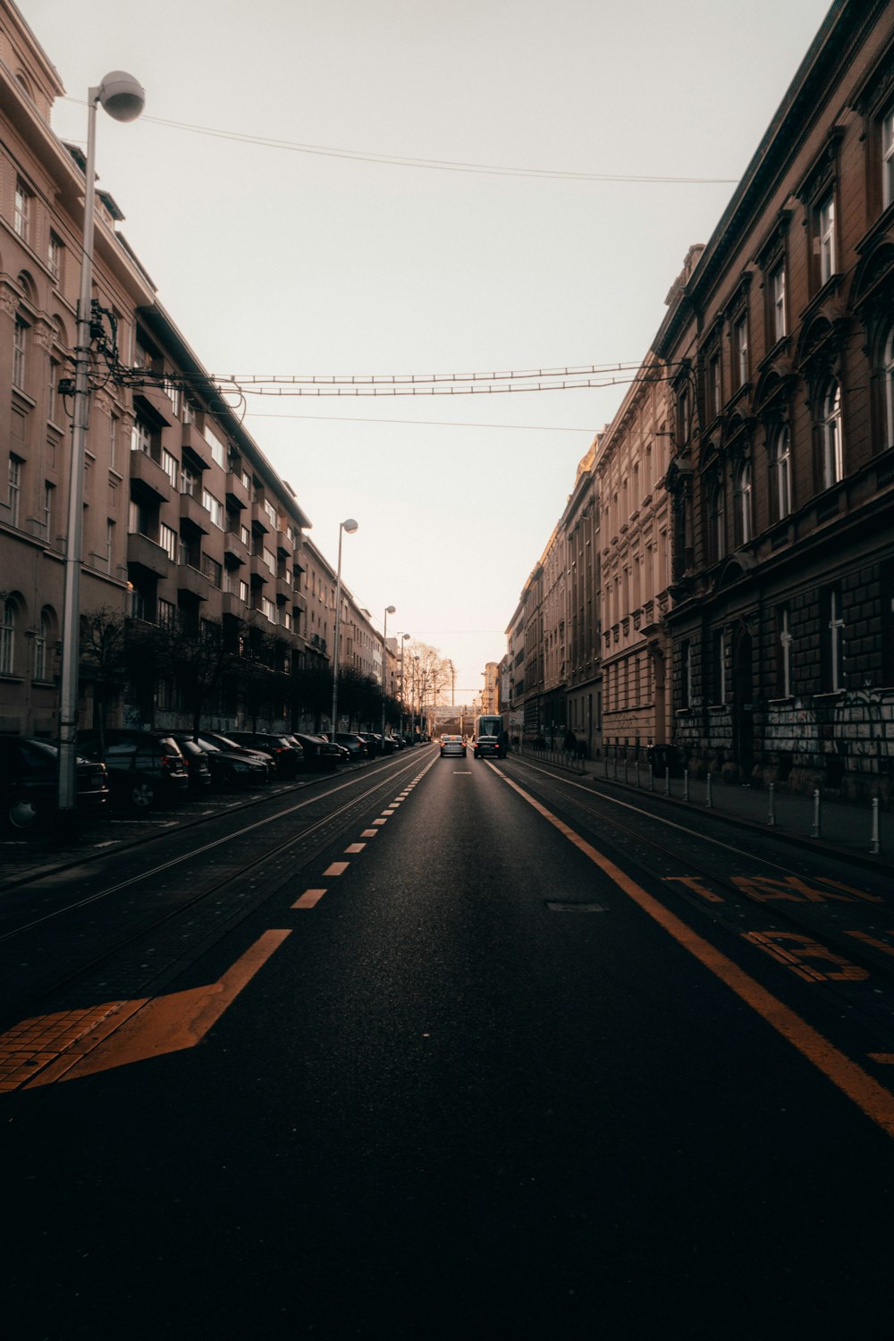 an empty street with cars parked on both sides