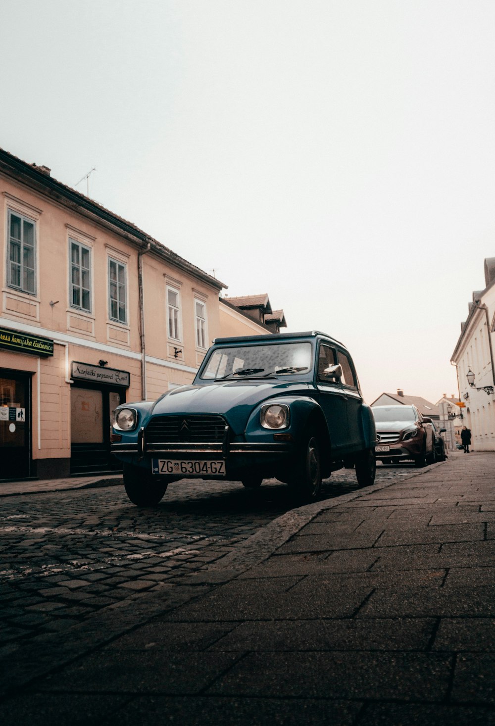 an old car parked on the side of the road