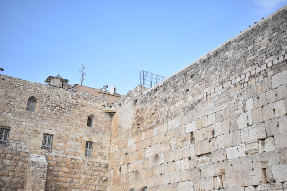 a large stone wall with a clock on it