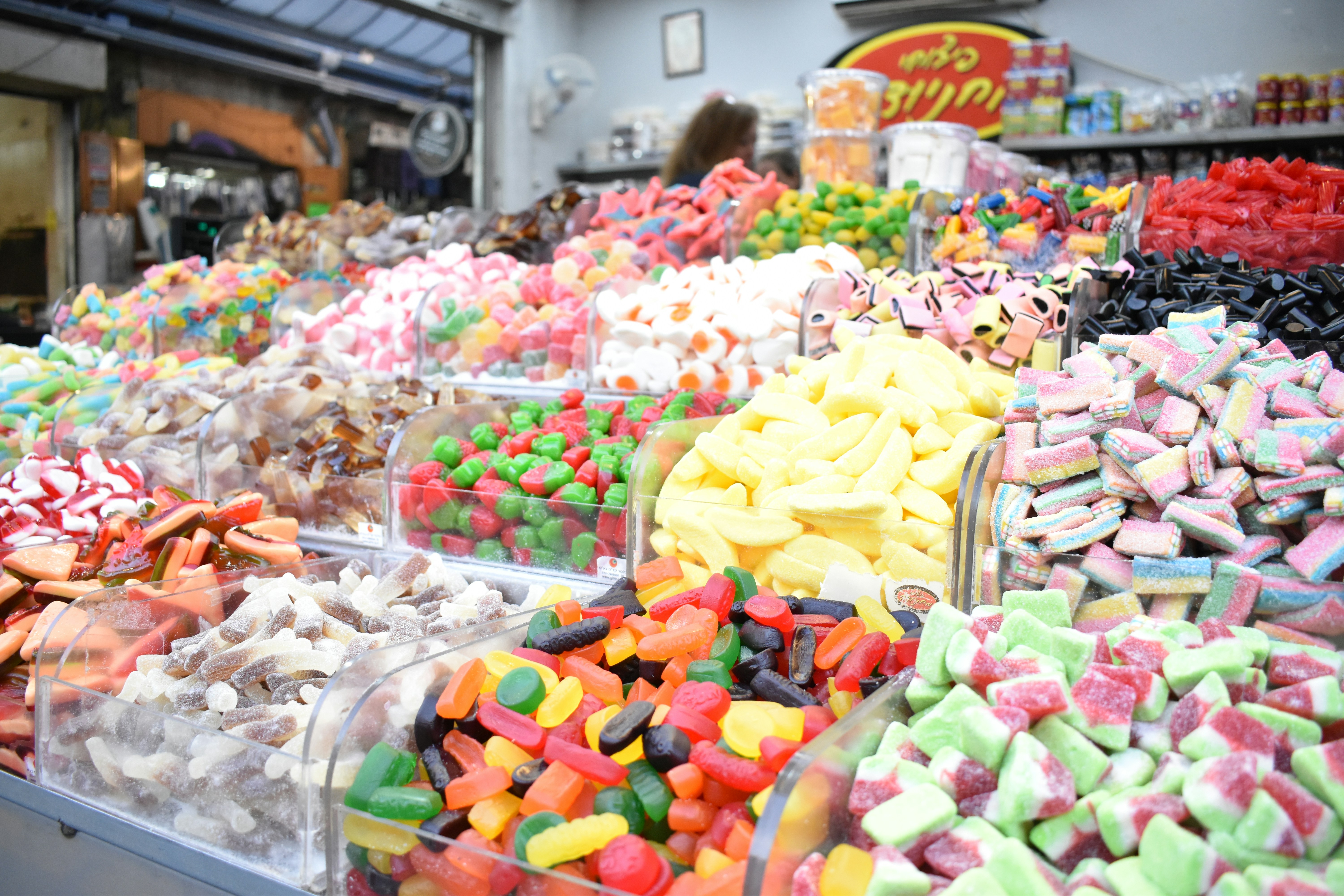a variety of colorful candies are on display in a store