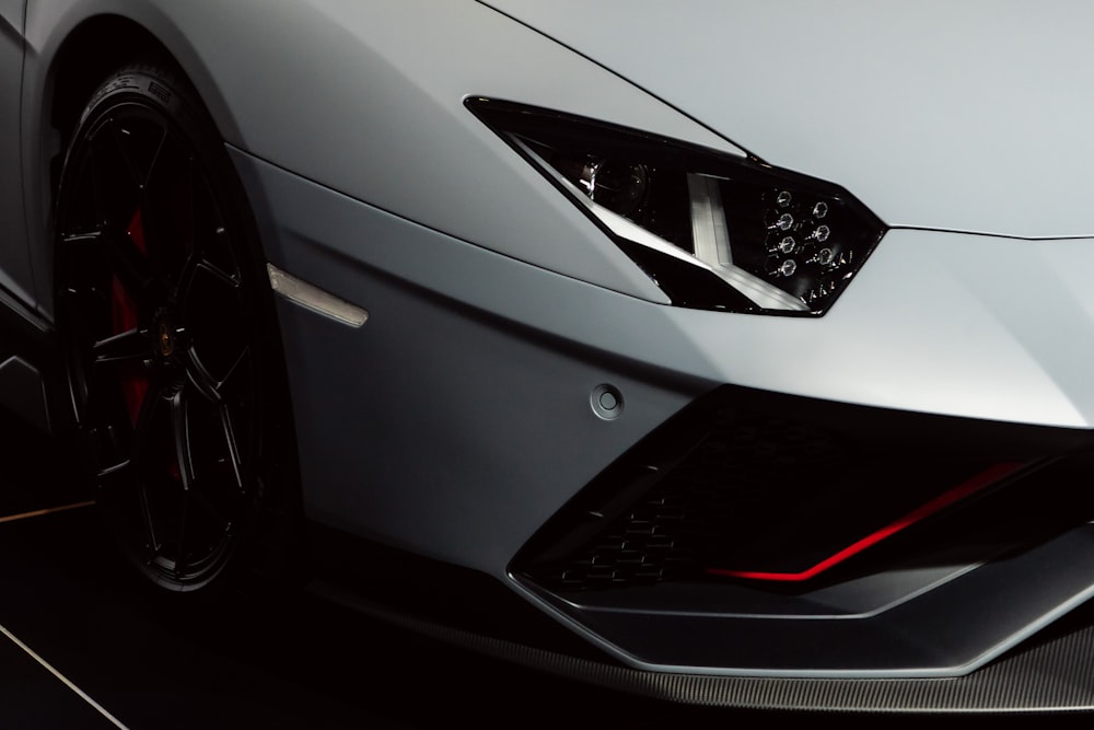 the front end of a silver sports car