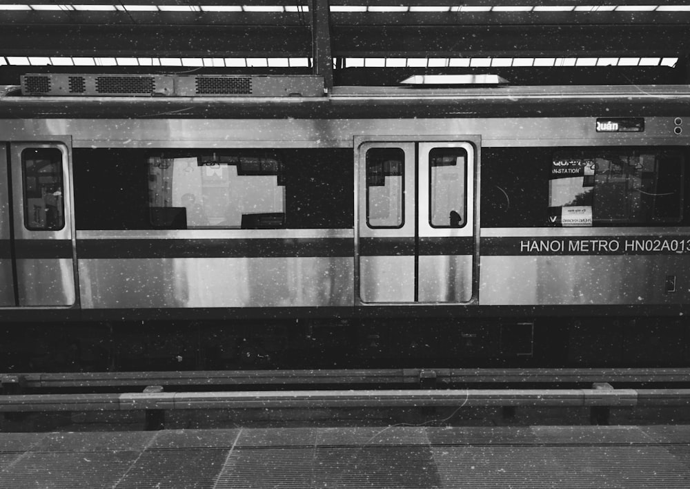 a black and white photo of a metro train