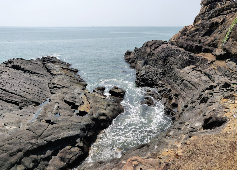 a view of the ocean from a rocky cliff