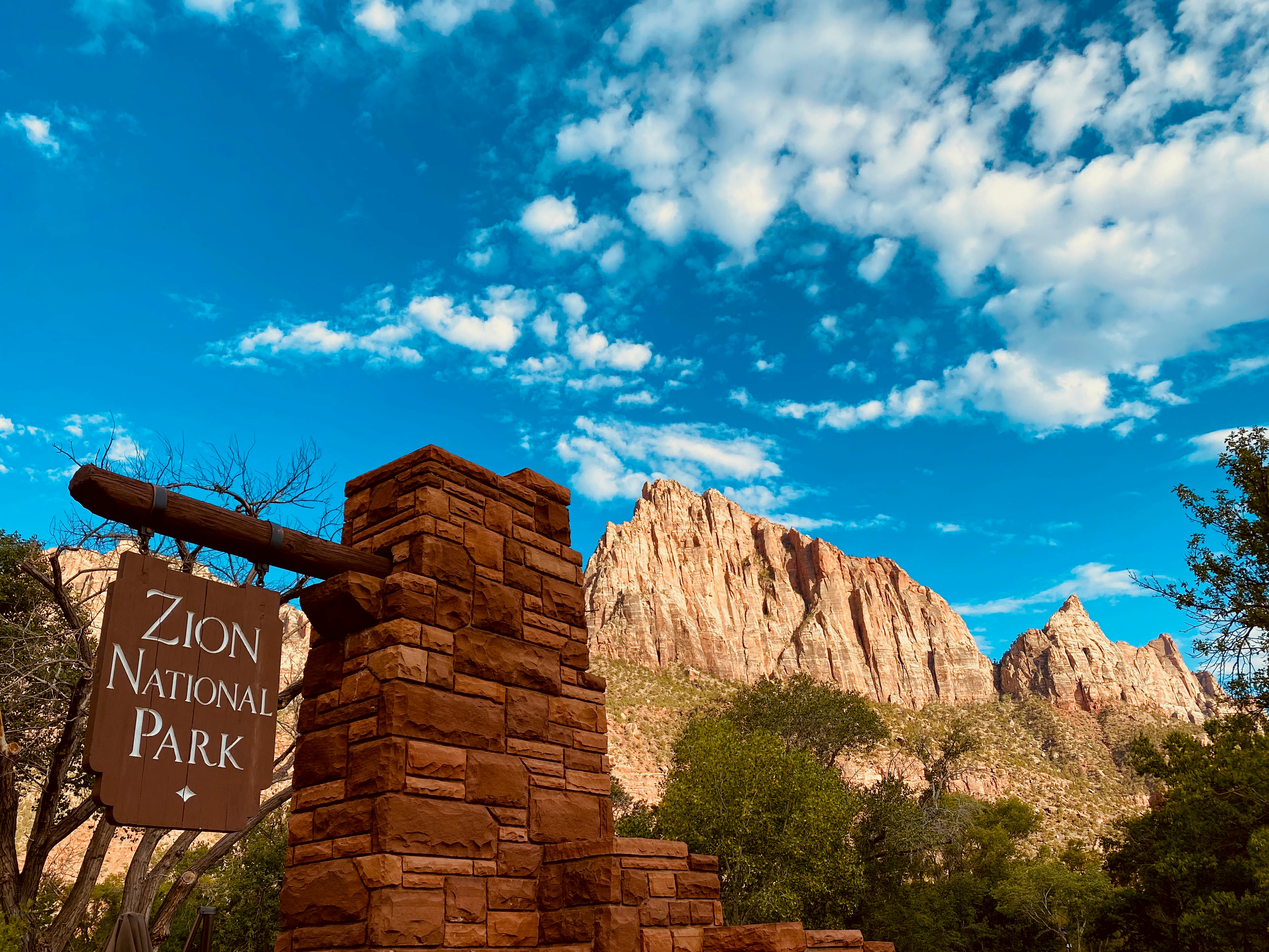 a sign that is in front of a mountain