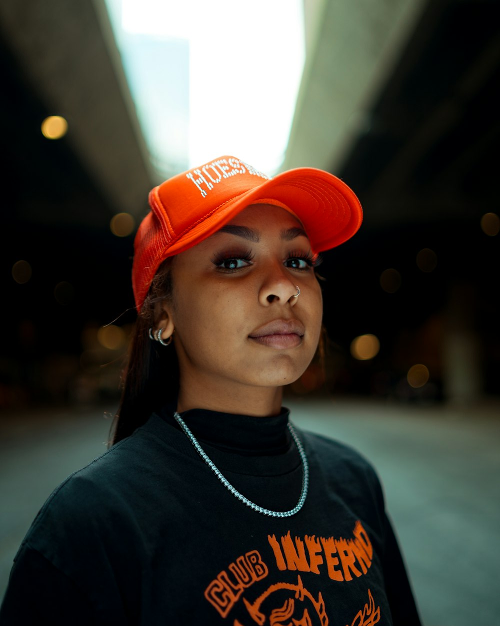 a woman wearing an orange hat and a black shirt