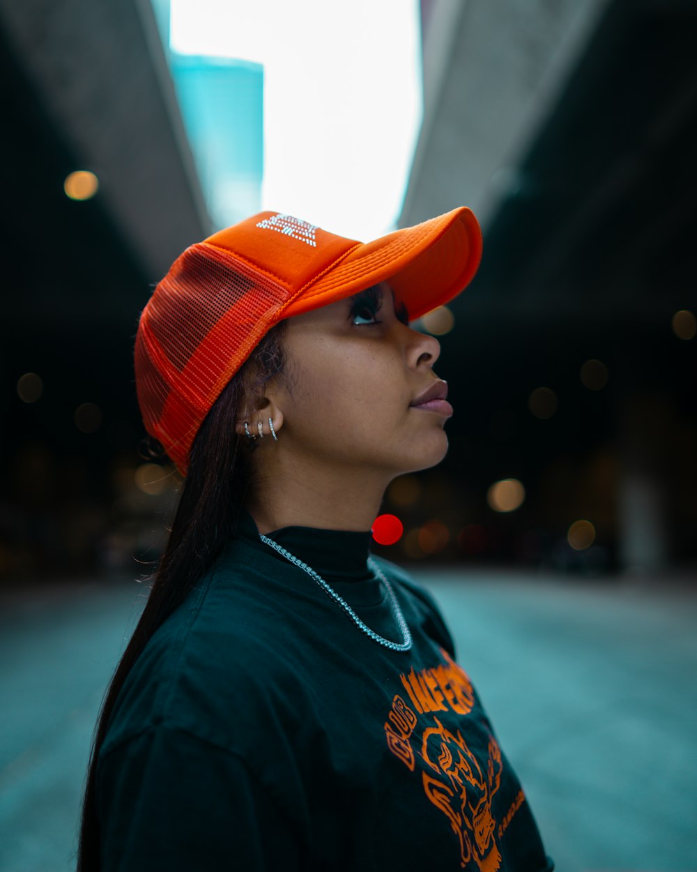 a woman wearing an orange hat and a green shirt