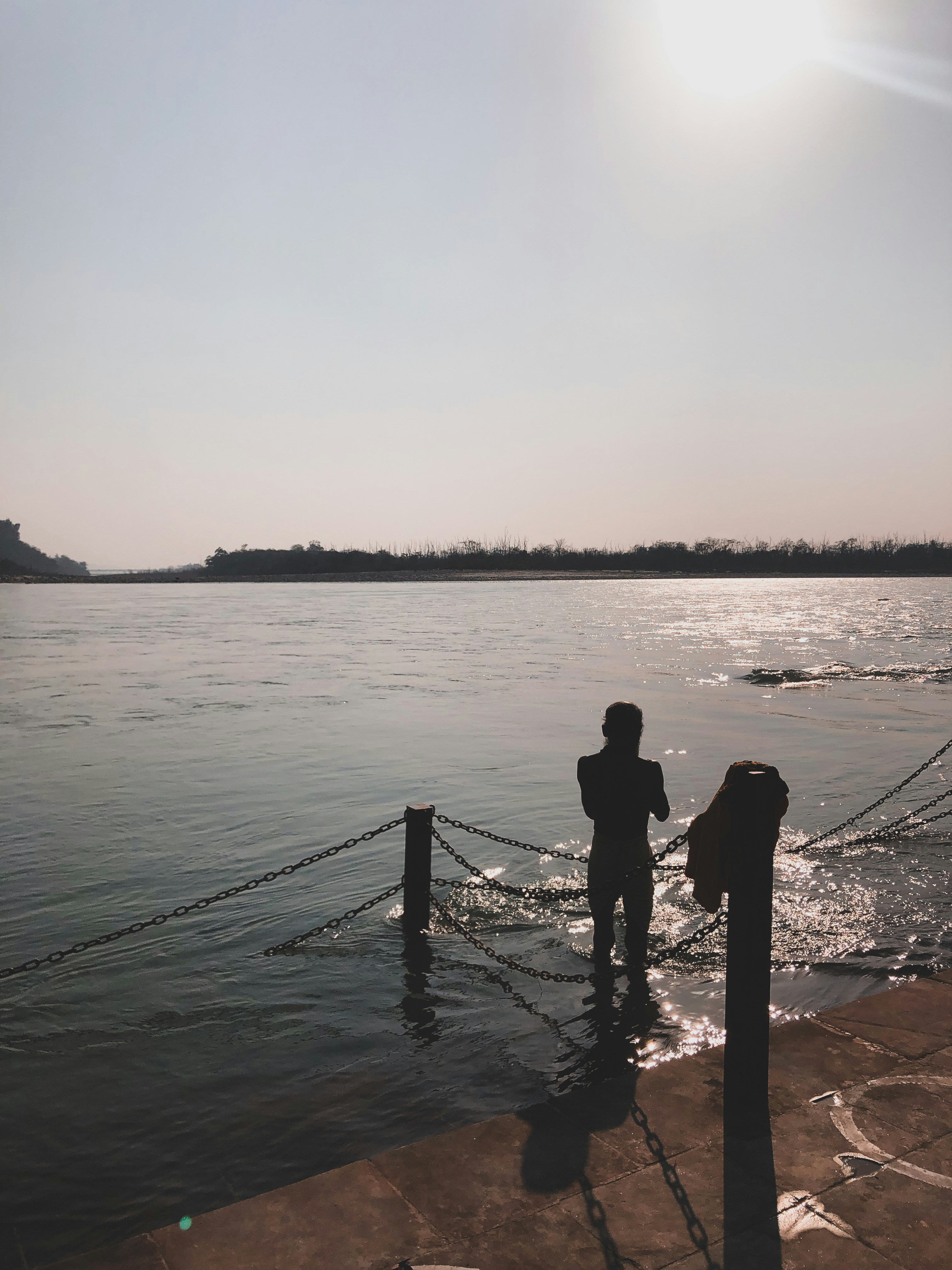 Ein Mann steht auf einem Dock neben einem Gewässer