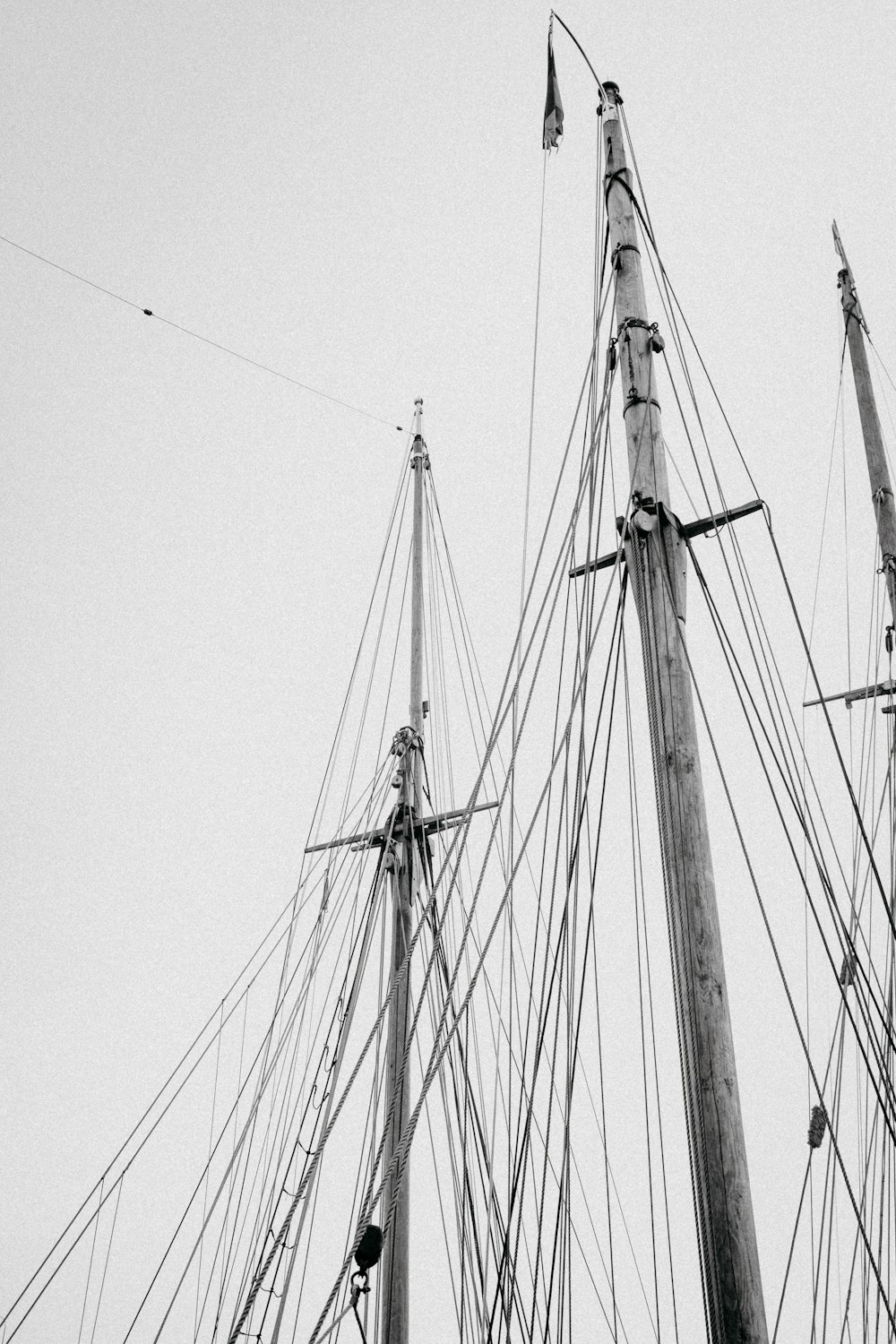 a black and white photo of the masts of a ship